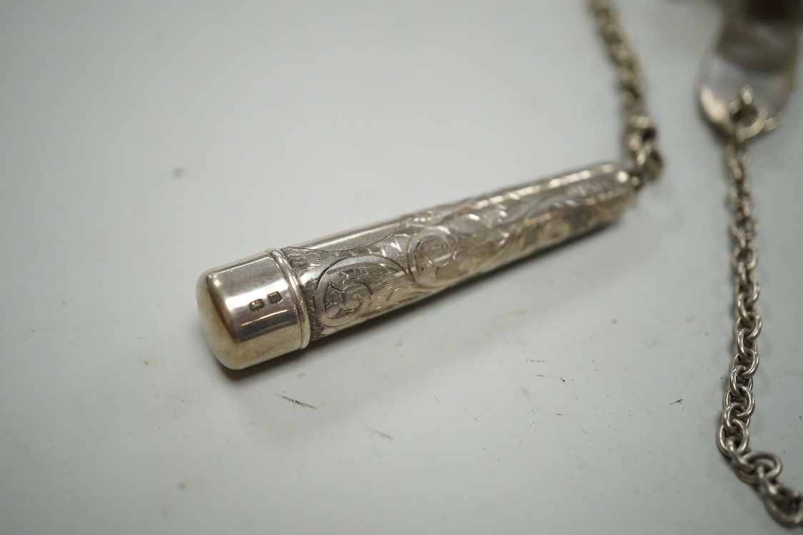 An Edwardian pierced silver chatelaine, by Samuel Jacob, London, 1902, with three accoutrements to include two silver cases and a enamelled fob watch, overall length 34cm.